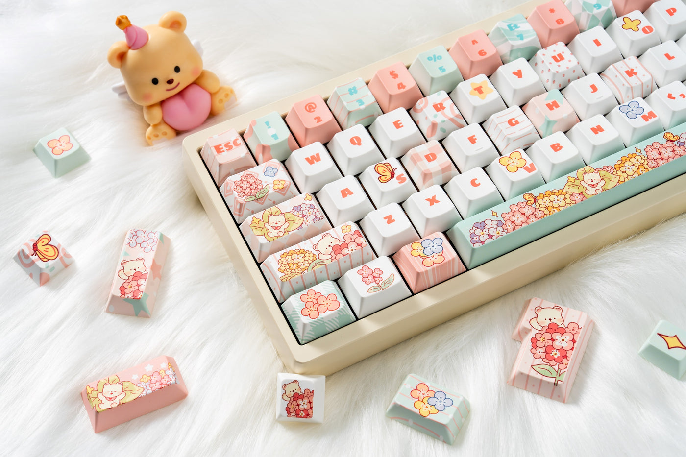 Bear Flora floral keycaps on a cream keyboard with a small bear figure and loose keycaps.