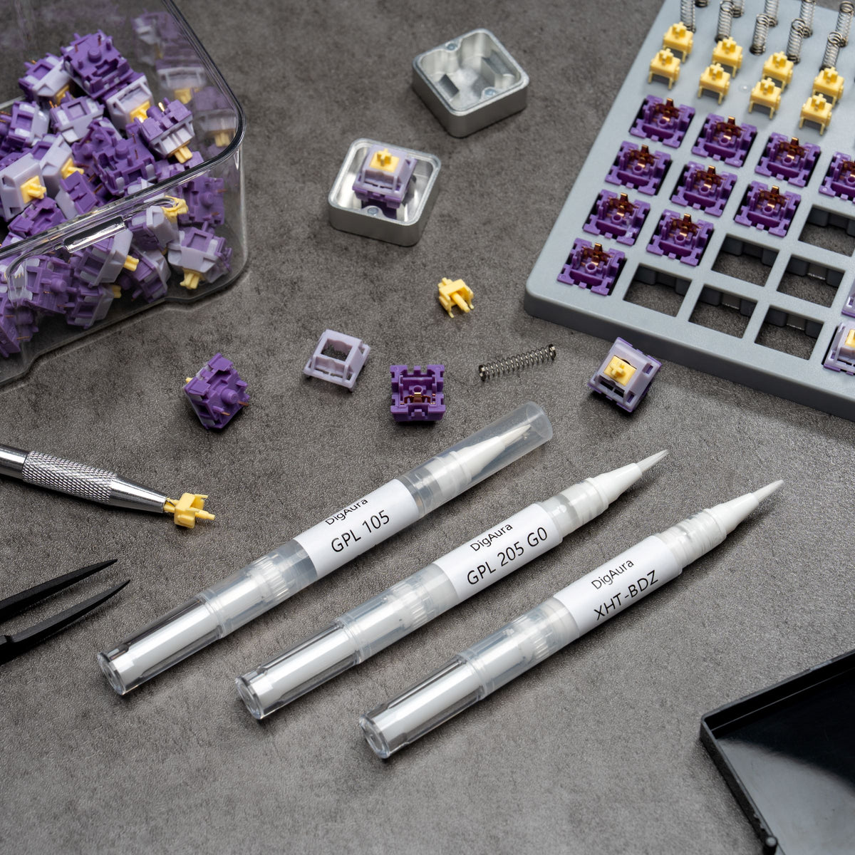 DigAura switch lubrication tools arranged on a workbench