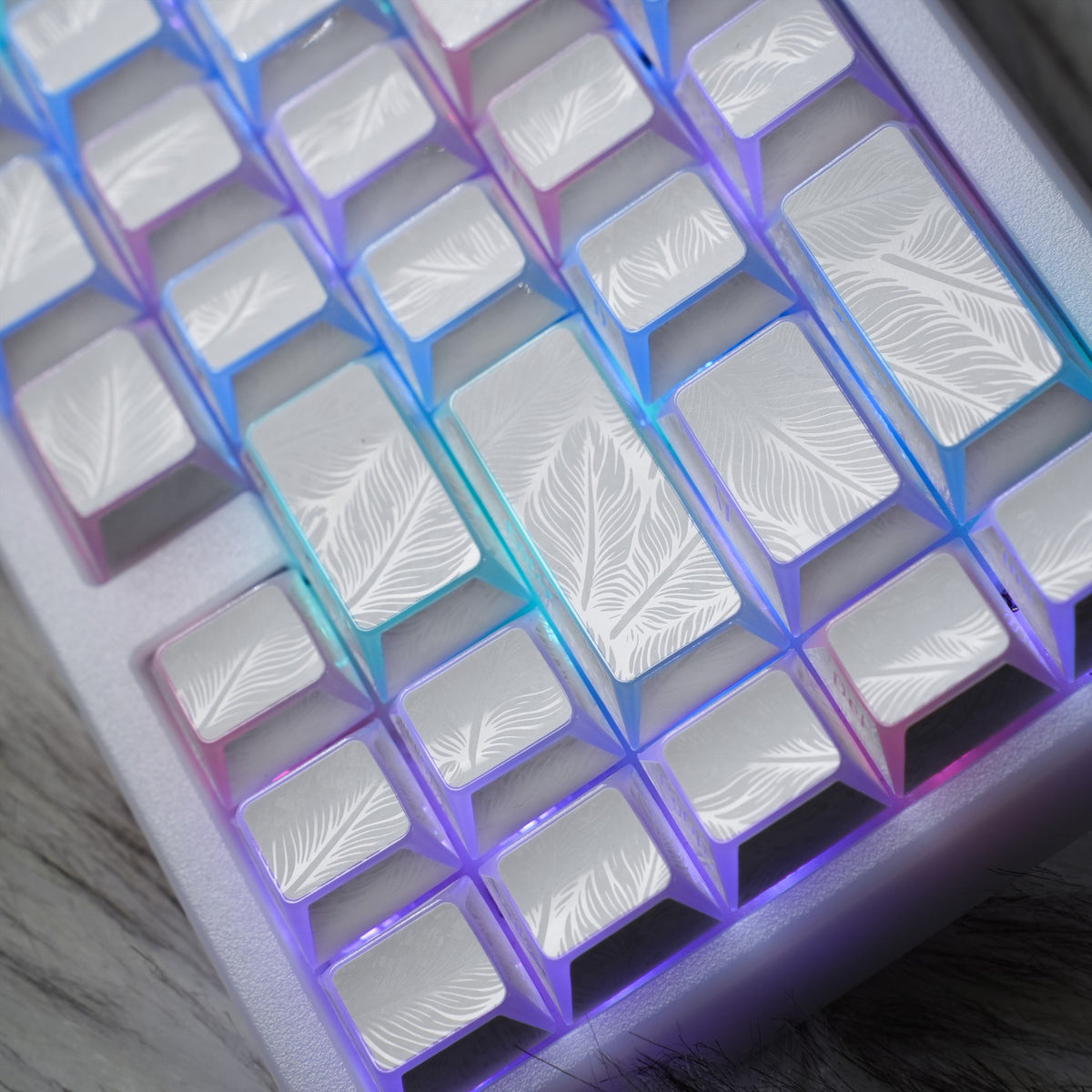 White Cloud Feather keycaps with feather-textured tops and translucent sides.